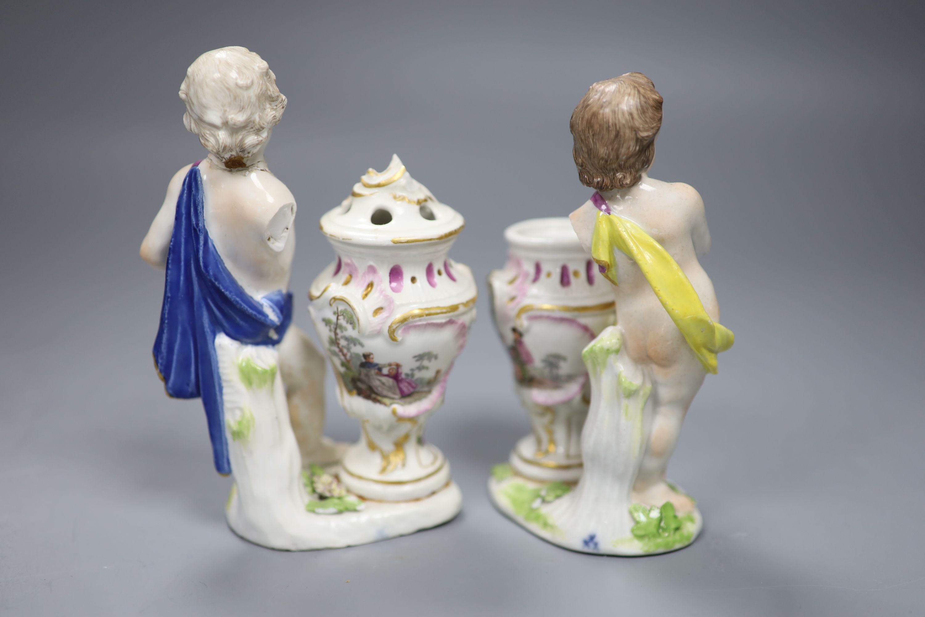 A pair of 18th century Meissen figures of putti and vases, height 14cm